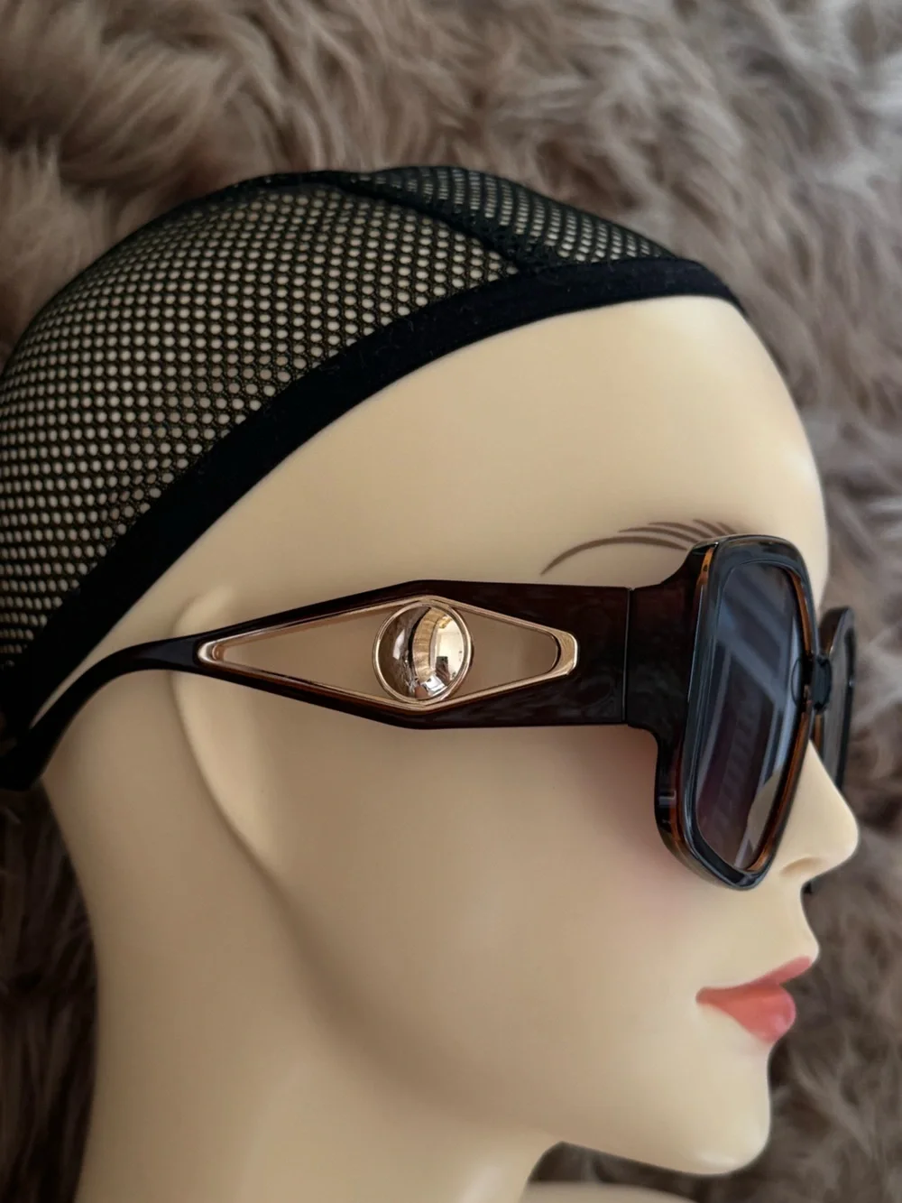 Futuristic sunglasses with large button detail on the sides